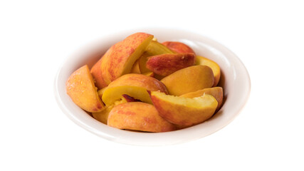 Bowl of fresh sliced peaches isolated on white background. Delicious and healthy fruit food
