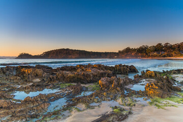 Fototapeta premium Winter's Sunrise at Surf Beach with Craggy Rocks