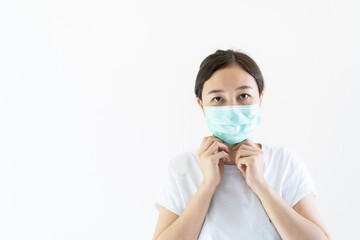 Asian young attractive woman wearing a protective hygiene mask over her face to protect flu and virus. 