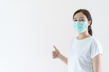 Asian young woman wearing a protective face mask.