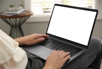 Woman working with modern laptop indoors, closeup. Space for design