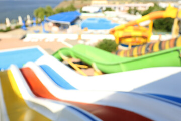 Fototapeta na wymiar Blurred view from colorful slides in water park