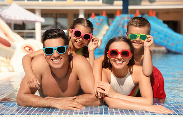 Happy family in swimming pool. Summer vacation