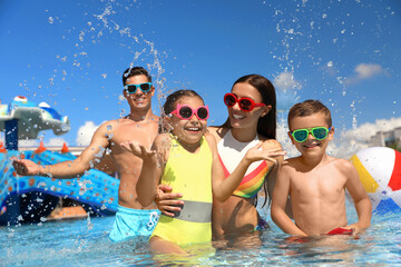 Happy family having fun at water park. Summer vacation