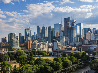 Downtown Toronto skyline: financial district skyscrapers with  blue cloudy sky in the background and park at the bottom