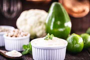 vegan mayonnaise, concept photo, mayonnaise made from vegetables without eggs or milk. Avocado cream, chickpeas, lemon, cabbage and sunflower seed.