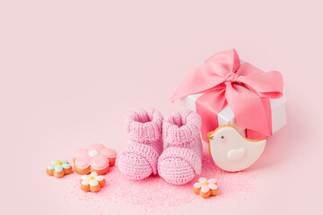 Pair of small pink baby socks, cookies, gift box on pink background with copy space for your warm message, baby shower, first newborn party background, copy space, monochrome - 369854073