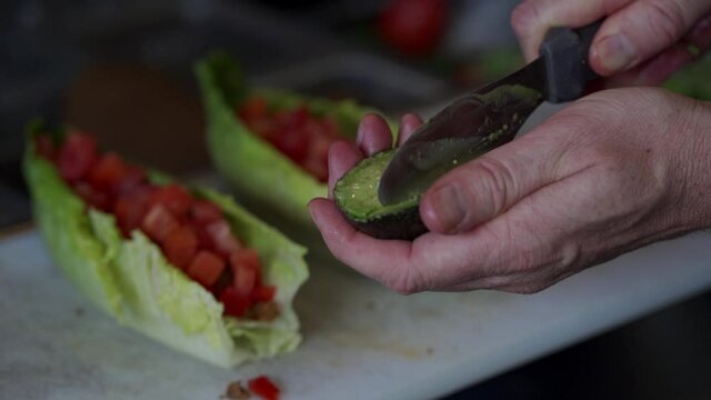 Slow motion Closeup of Slicing Avacodo for a wrap.