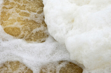 White sponge heap on seethe of the stream
