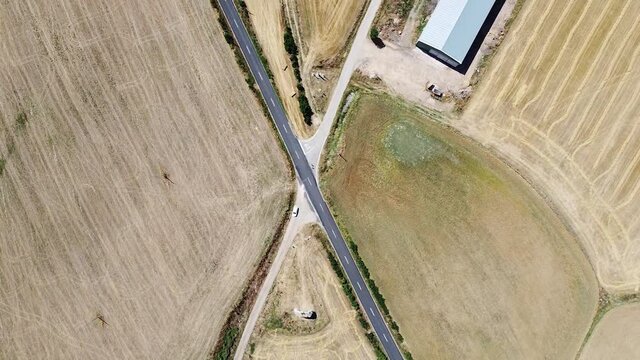 Descending aerial shot of crossroads in front of Arco de San Miguel de Mazarreros