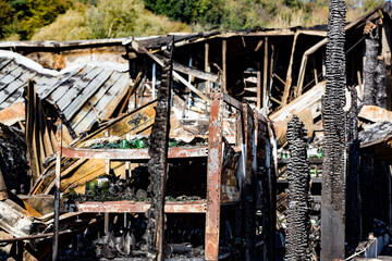 Close up Burned damaged ruins of destroyed bottles on shelf supermarket arson investigation insurance