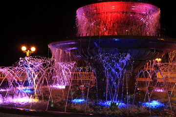 Image of a fountain with multi-colored lanterns.