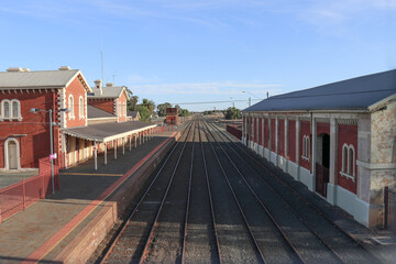 ECHUCA, AUSTRALIA - February 29, 2020: A view of the Echuca railway station platform, water tank and goods shed from the pedestrian footbridge overpass