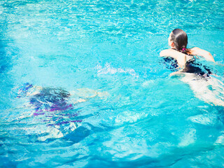 Cheerful senior woman relaxing in swimming-pool