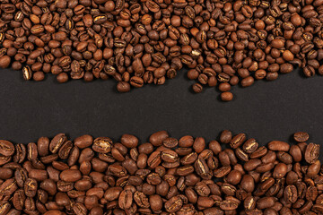 Roasted coffee beans. Two sorts of arabica on black background