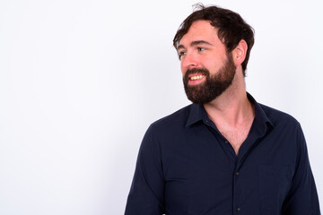 Obraz premium Portrait of happy handsome bearded businessman against white background