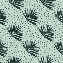 Hand drawn seamless pattern with bush leaves. Light blue background with dots and dark green tropical foliage ornament.