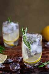Lemon drink cocktail with rosemary and ice.