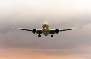 Air Plane on sky with sunlight and cloud going to landing  on the airport,Thailand.