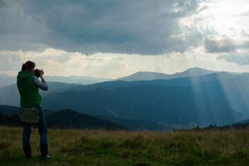 Fototapeta na wymiar photographer in Ukraine Carpathians shoots a landscape