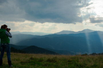 Fototapeta na wymiar photographer in Ukraine Carpathians shoots a landscape