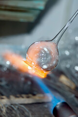Close-up of a flame and melting glass piece that is to be a magnificent christmas ornament