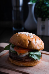 delicious angus beef burger with lettuce, tomato, cheese, and onion