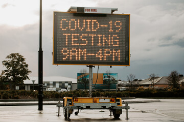 Covid-19 pandemic testing sign, with focus on the trailer