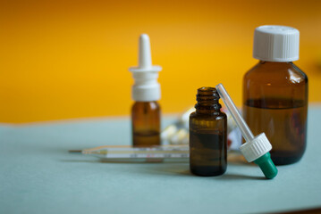 Medicines for colds, flu, viral diseases. Cough and cold remedies. Glass jars with syrup, colored...