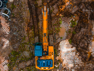 Aerial drone view of excavator loading the tipper truck at the construction site