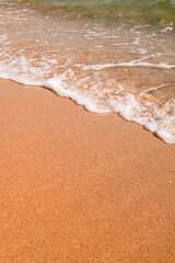 Tourist travel banner design template, copy space. White foam of a sea wave, golden sand beach, turquoise ocean water.