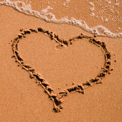 Heart drawn on sand, seacoast. Golden sand beach close up, summer holidays border frame concept.