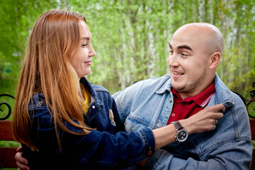 Kirov, Russia - June 22, 2020: European couple of blonde woman and bald man walking at park, enjoying and being happy together. Love and tenderness concept. Lovers on date outdoors at nature.