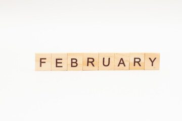 Word February made of wooden blocks on white background. Month of year