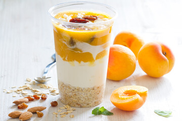 Yogurt with oatmeal, apricots, raisins and almonds. Healthy and nutritious snack