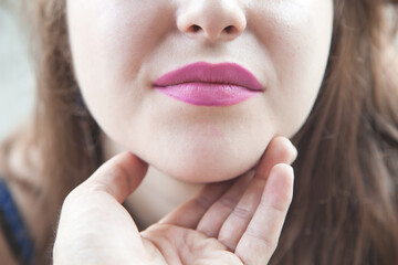 Male hand showing woman lips.