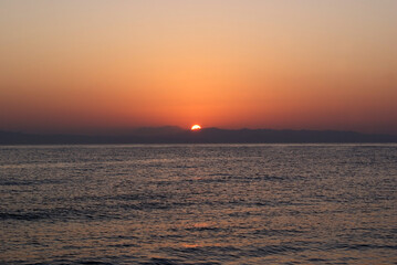 Beautiful dawn over the sea. Sunny path on the water. Light wave and swell on the surface of the water