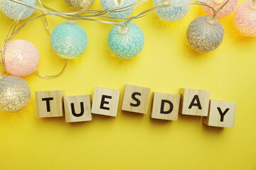 Tuesday alphabet letter with LED Cotton ball Decoration on yellow background