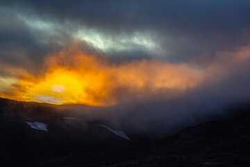 Naklejka na ściany i meble Sunset in mountain and misty terrain of Iceland. Nature and places for wonderful travels