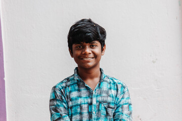 Portrait of an Indian kid laughing while staring at the camera	