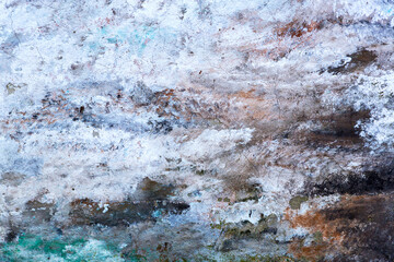 Abstract creative background of chaotic strokes of old cracked paint on concrete wall. Old surface with traces of paint, weathered, scratches and cracks for design