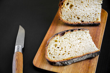bread slices and knife on a wooden cutting board