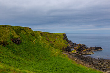 The coastal view of Giant's Causeway, in North Ireland, on a cloudy day.