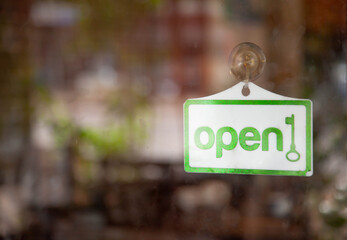 A business sign that says &lsquo;Open&rsquo; on cafe or restaurant hang on door at entrance.