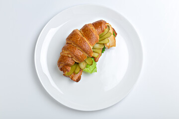 Sandwich croissant in plate for breakfast close up