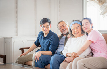 Asian family sitting in living room, Senior father mother and middle aged son and daughter, Happiness family concepts