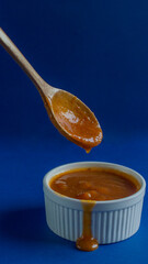 Apricot jam is healthy sweetness in white glass jar, witch contains lot of vitamins, carbs, fiber. Healthy fruit jam prepared with apricot and sugar,  vertical, orientation.