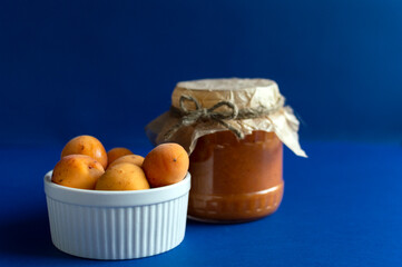 Healthy fruit jam prepared with apricot and sugar,  horizontal orientation.Apricot jam is ...