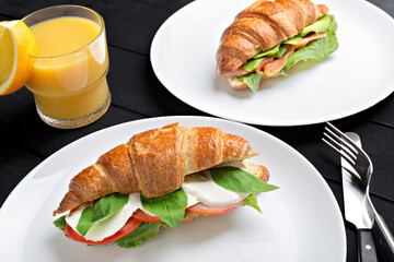Sandwich croissant in plate for breakfast close up