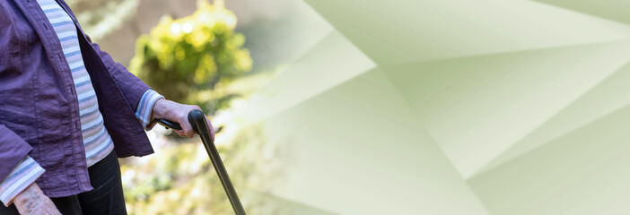 Elderly woman holding a walking stick; panoramic banner